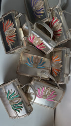 Lifestyle layout of the Lotus Treasure collection next to gold bangles and raw silk coordinates.