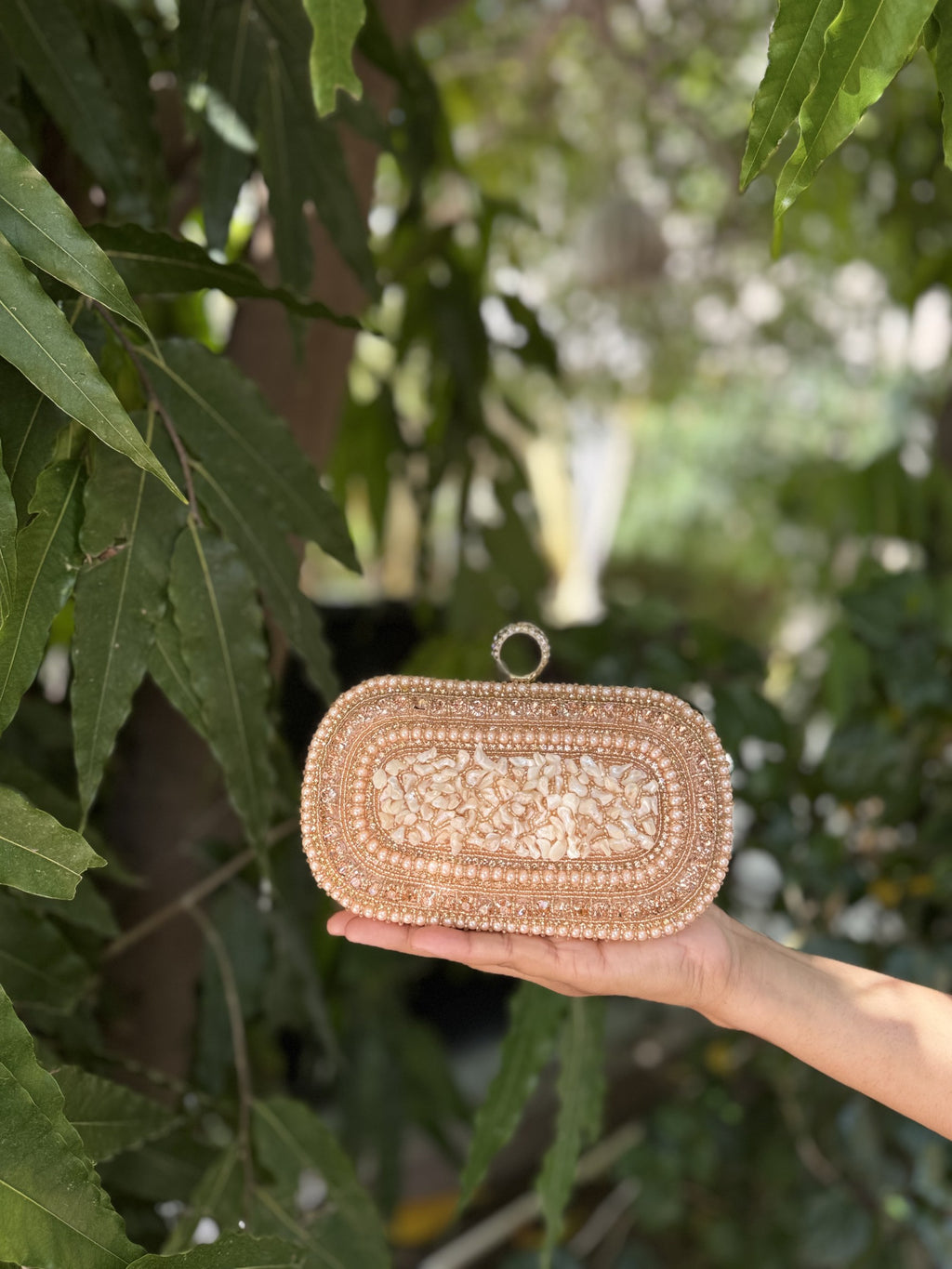 Side profile of the structured jute box clutch, showing the gold frame border.