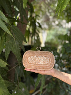 Side profile of the structured jute box clutch, showing the gold frame border.