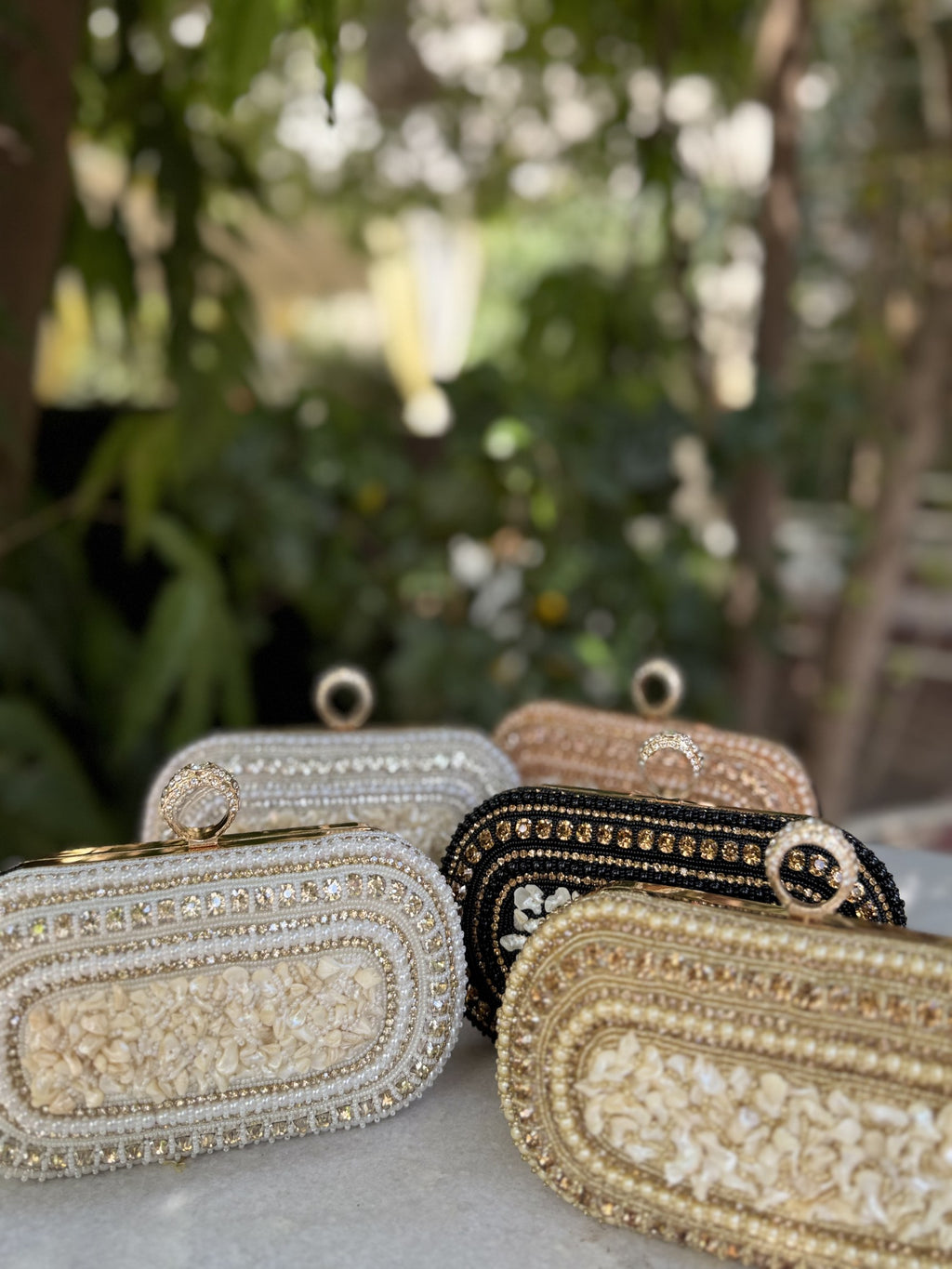 The Luxe Grip clutch styled over the shoulder with its gold-tone chain.