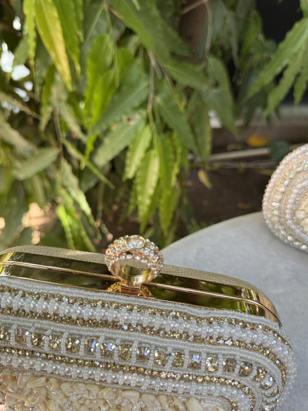 Lifestyle layout of the Luxe Grip clutch next to linen wear and beach coordinates.