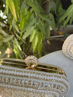 Lifestyle layout of the Luxe Grip clutch next to linen wear and beach coordinates.