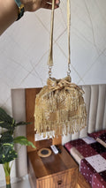 Front view of the restocked Majestyy Embellished Potli bag, displaying rich gold beadwork and dense sequins.