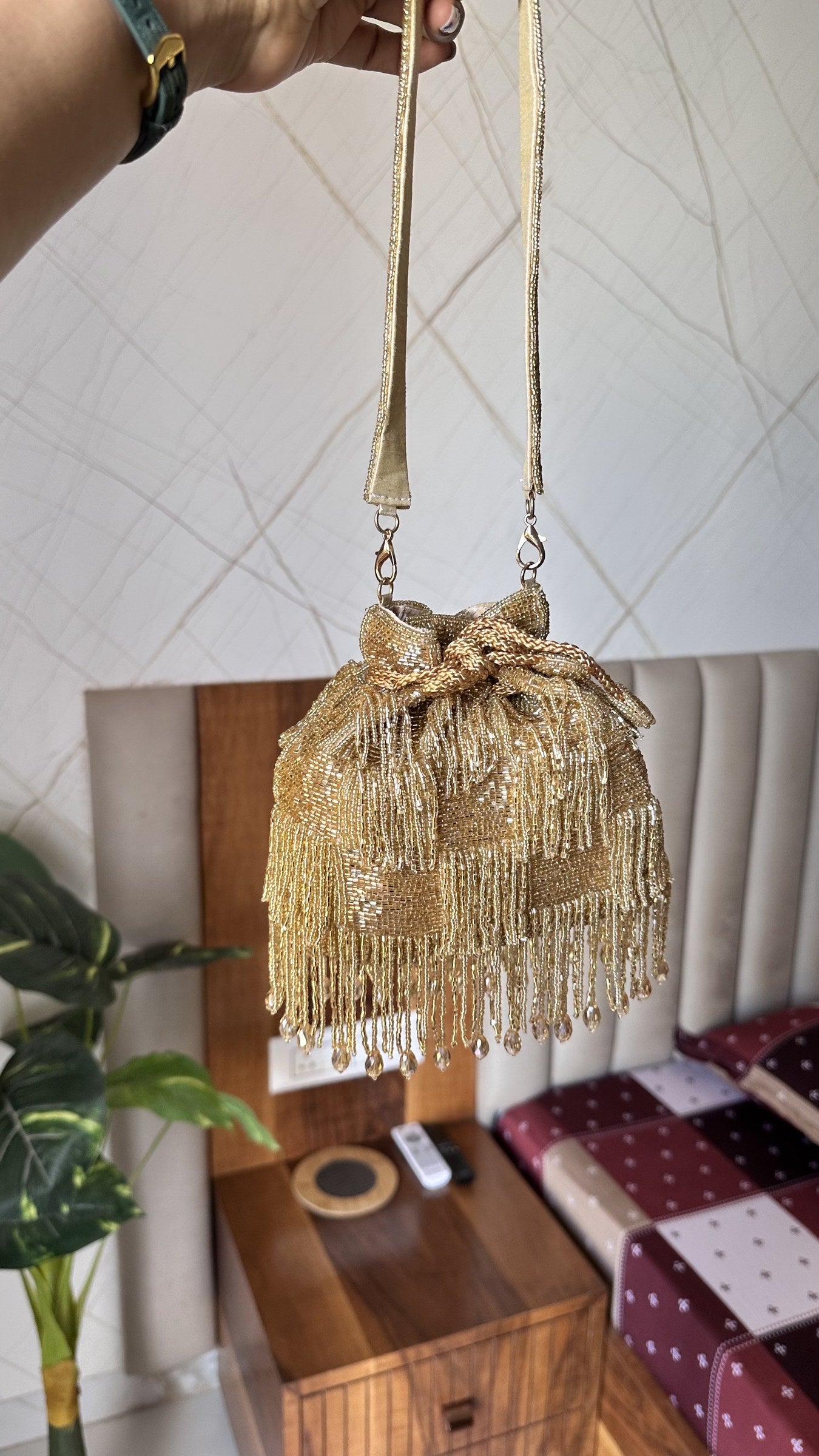 Front view of the restocked Majestyy Embellished Potli bag, displaying rich gold beadwork and dense sequins.
