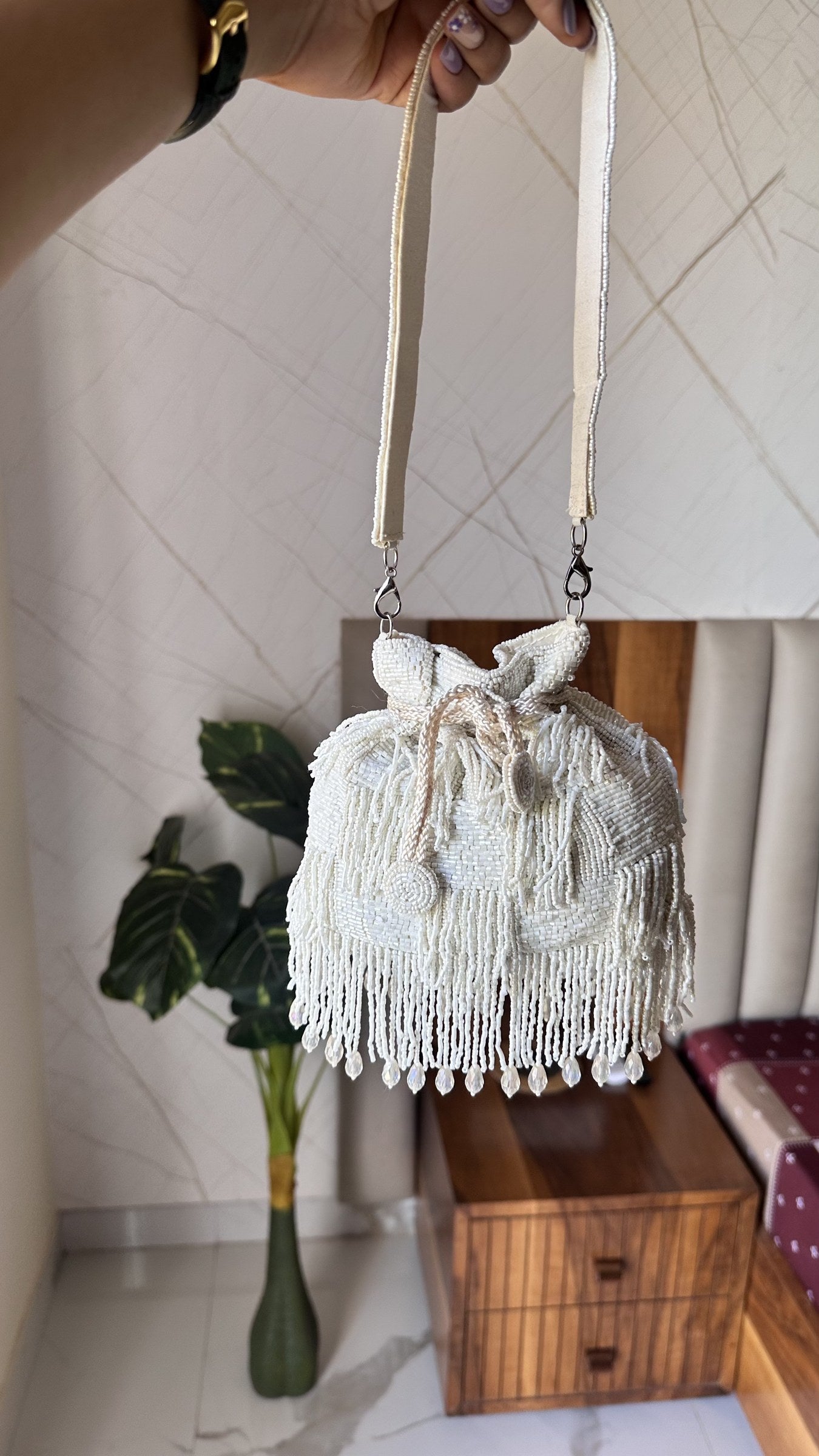 Close-up of the gold-tone drawstring cord and the elaborate beaded tassels of the Majestyy bag.