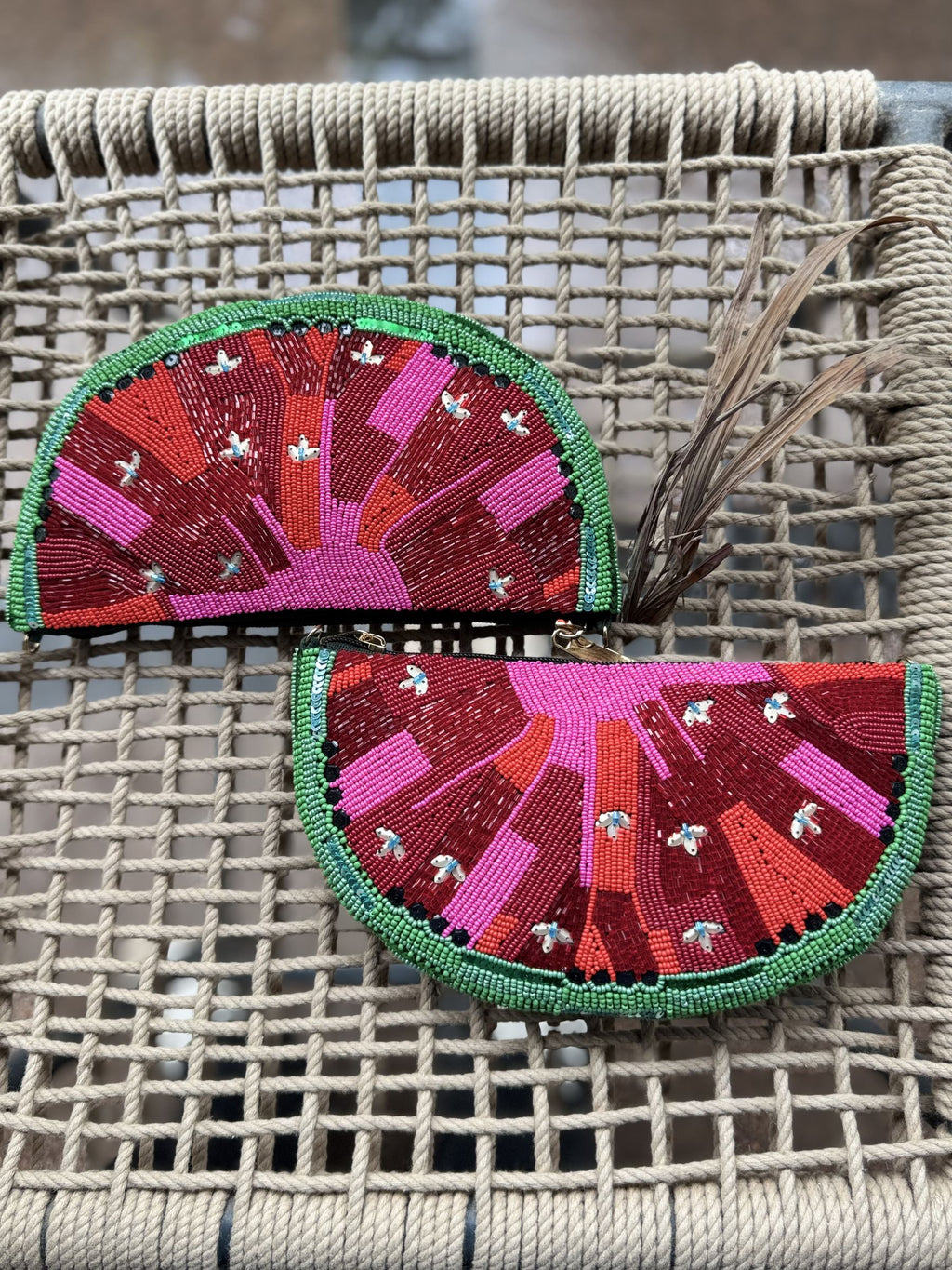 Open view of the watermelon bag displaying the secure zipper closure.