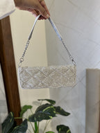 Side angle of the Midnight Mosaic bag displaying its slim profile and gold clasp.