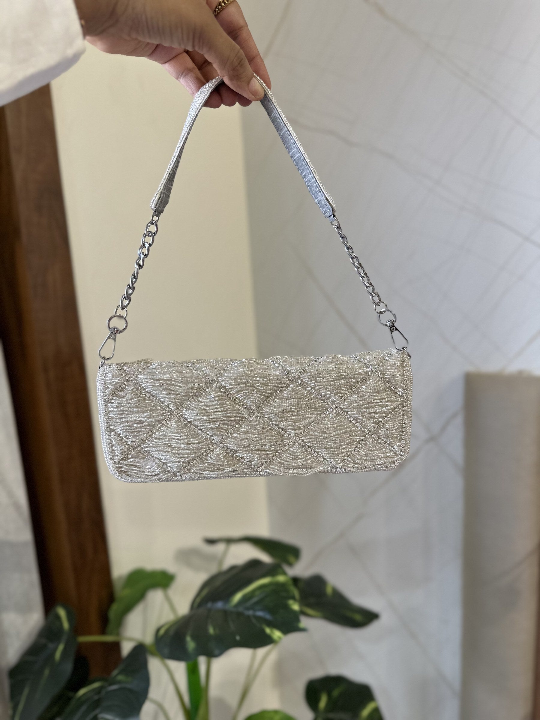 Side angle of the Midnight Mosaic bag displaying its slim profile and gold clasp.