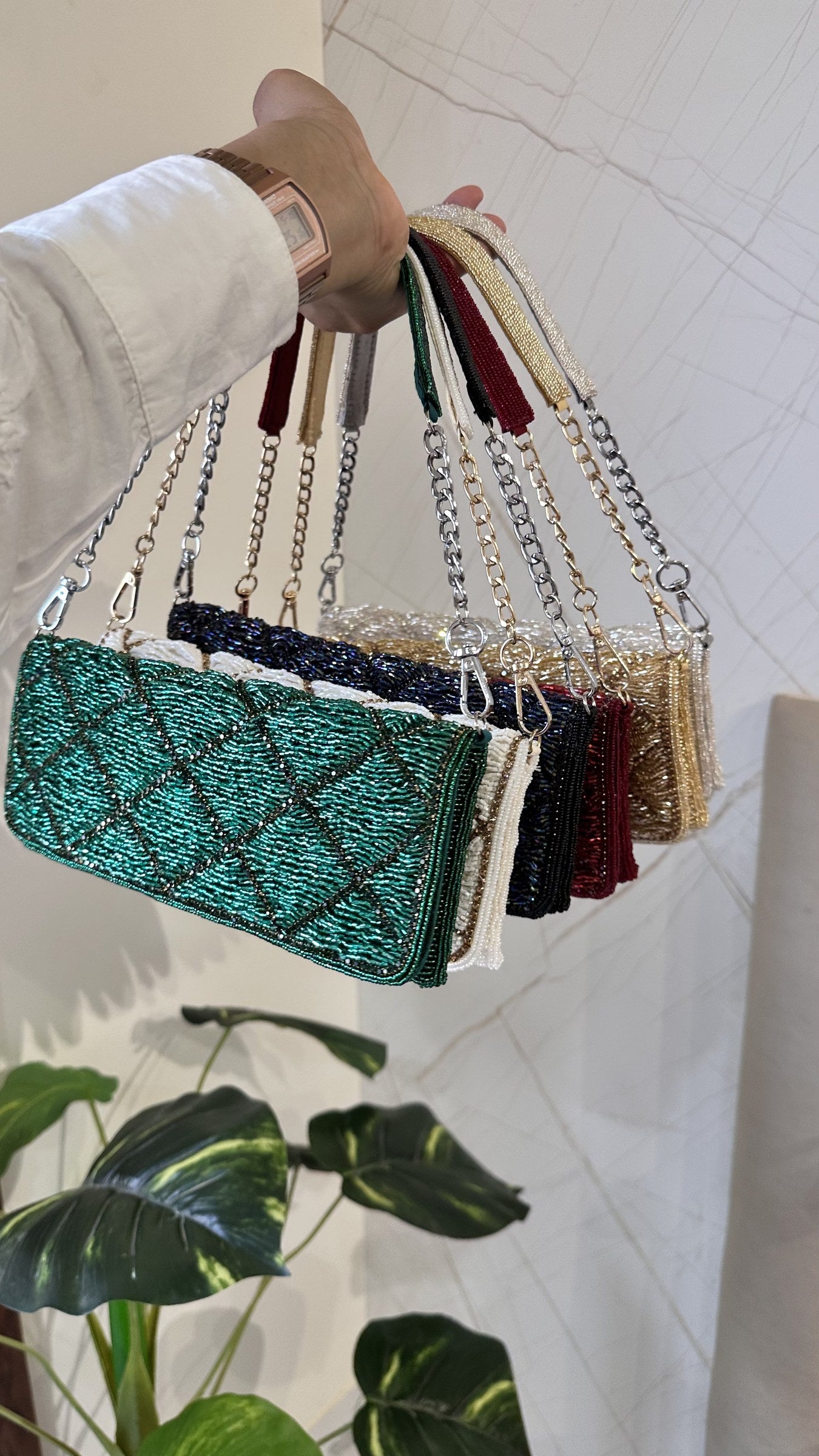 Model wearing the Midnight Mosaic bag on the shoulder, showing the drape of the gold chain.