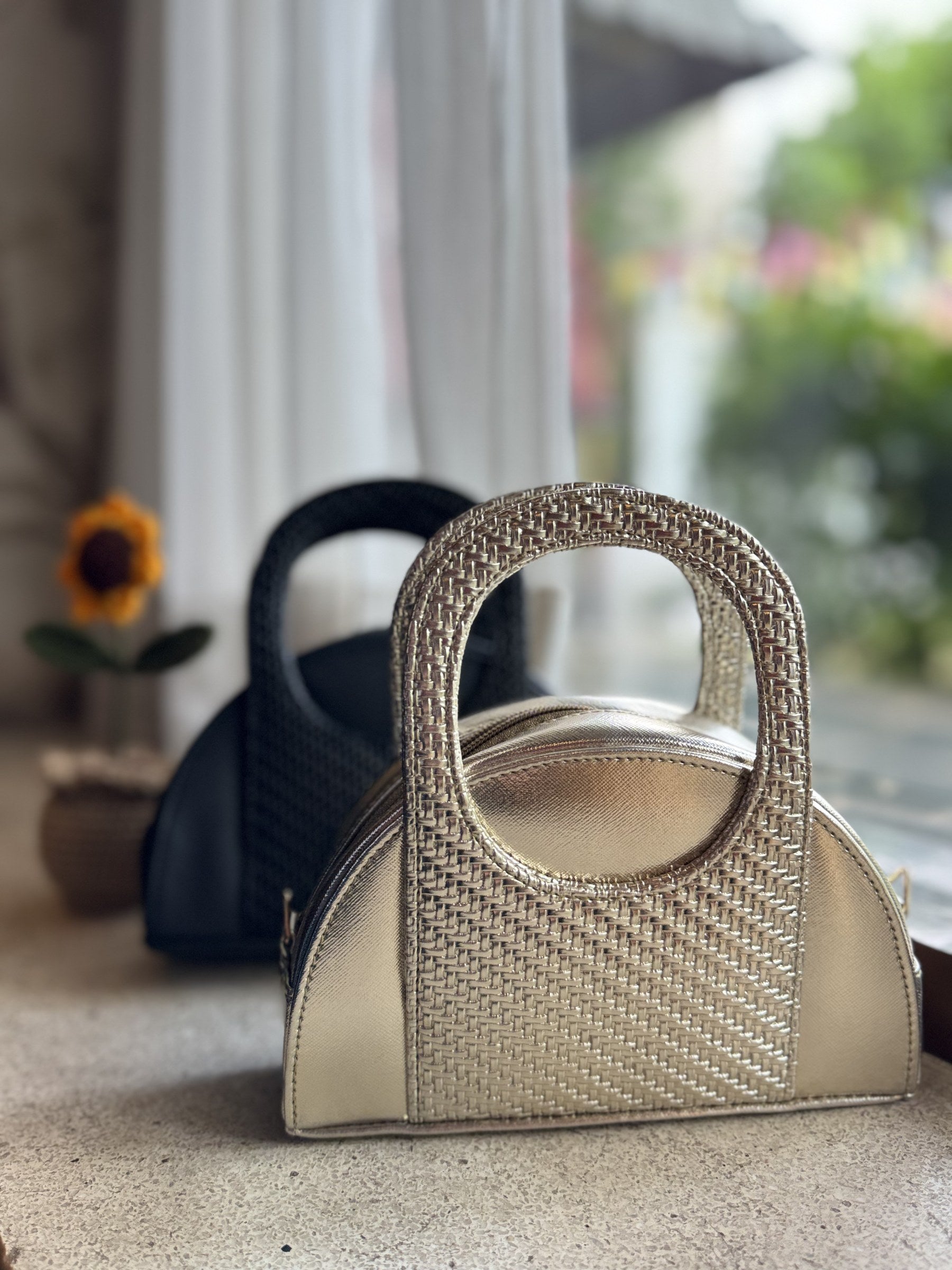 Side angle of the Mini Mood bag showing its slim, lightweight profile.