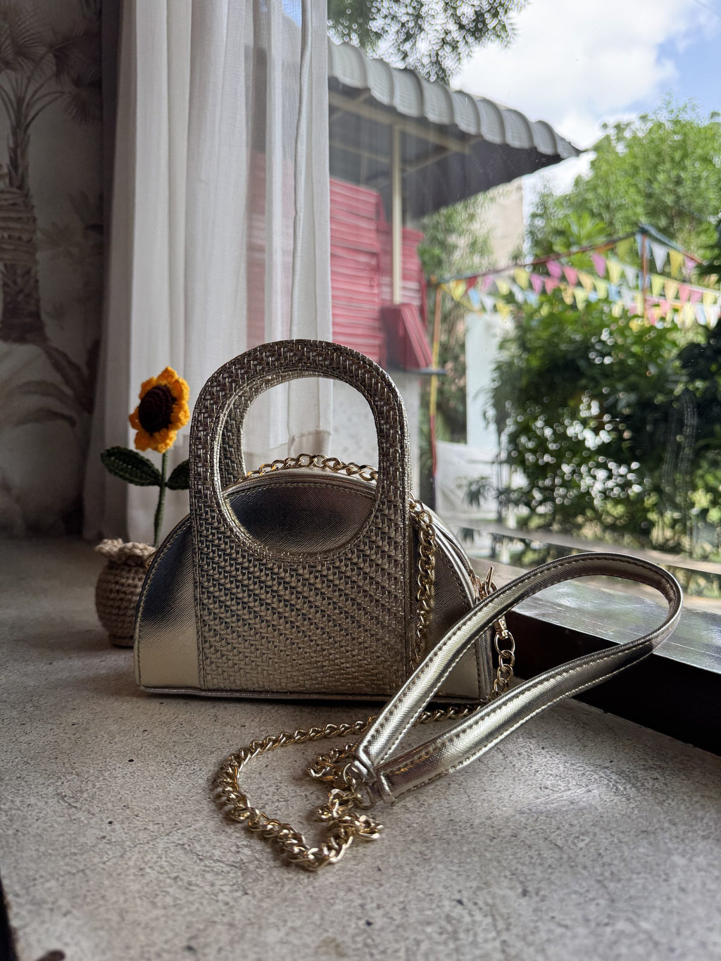 A model styling the Mini Mood sling over a summer linen dress for a casual cafe look.