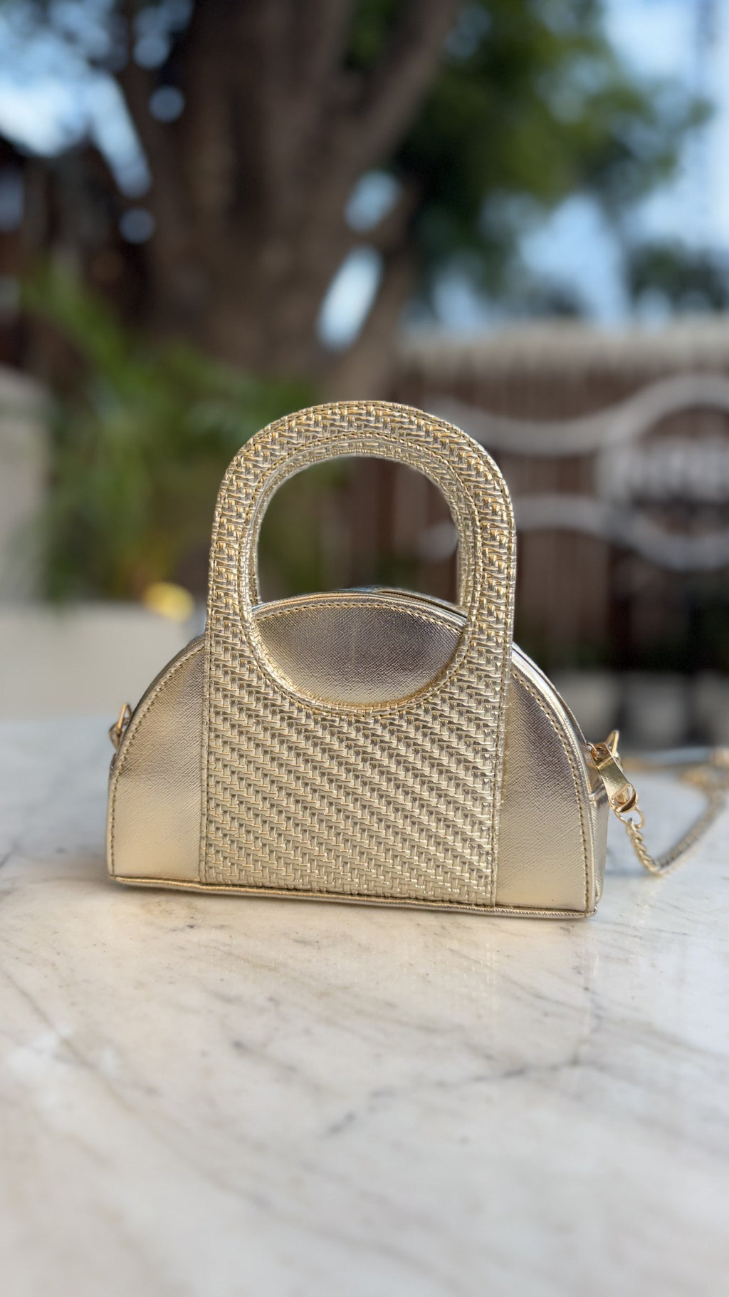 The Mini Mood bag shown next to a smartphone and keys, illustrating its daily capacity.