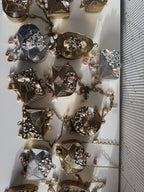 Mini Muse handcrafted metal bag displaying its gold and silver textured panels and short chain.