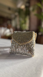Mini Saanjh mixed metal clutch displaying its gold and silver interwoven mesh panels.