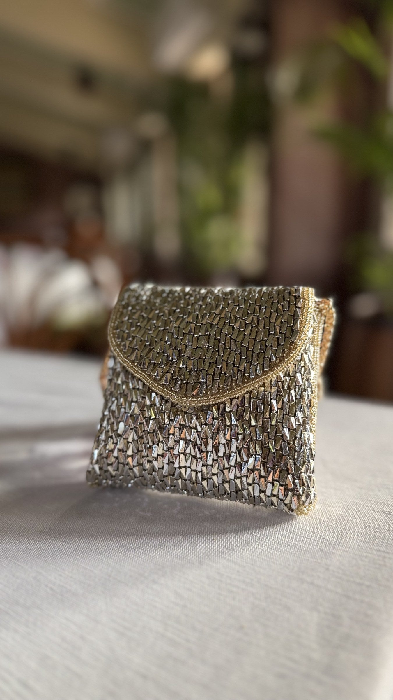 Mini Saanjh mixed metal clutch displaying its gold and silver interwoven mesh panels.