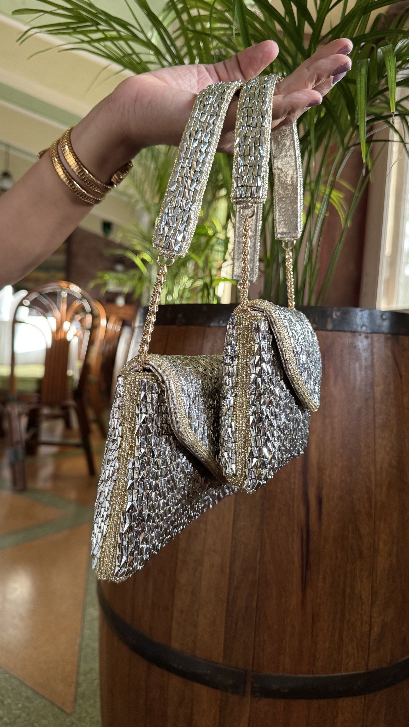 Side profile of the Mini Saanjh clutch showing the polished gold borders and clasp lock.