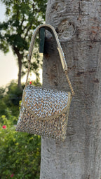 Detailed shot of the gold-tone metal loop attachments for the detachable chain.
