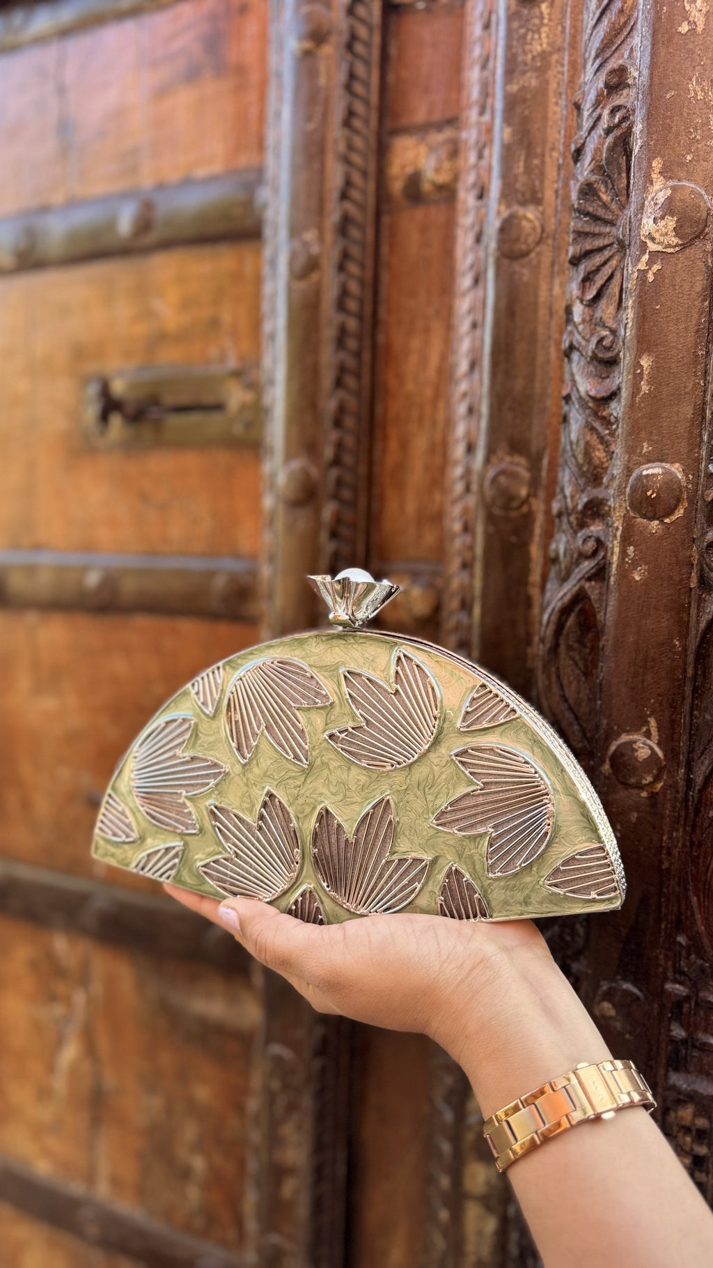 Mint Muse brass clutch showing its dreamy mint-green enamel panels and hand-sculpted gold petals.