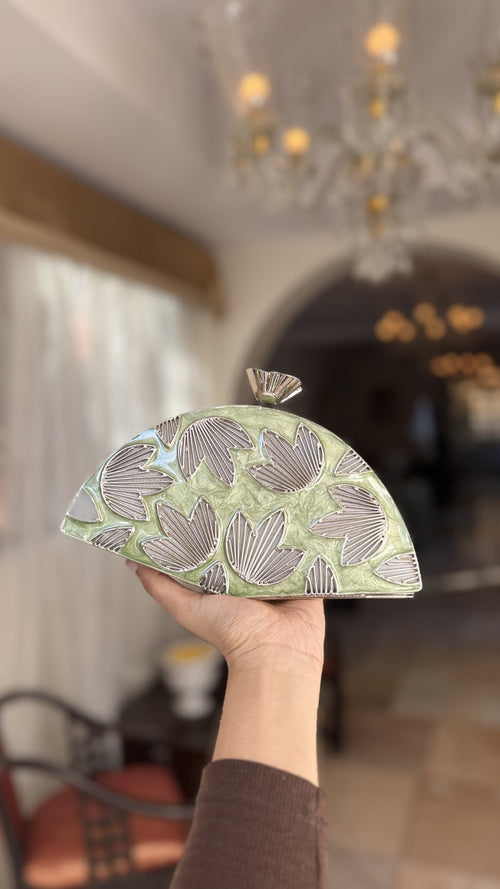 Detailed close-up of the three-dimensional gold petals rising from the mint enamel base.