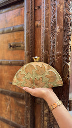 Front view of the Mint Muse clutch, highlighting its elongated rectangular frame and gold borders.