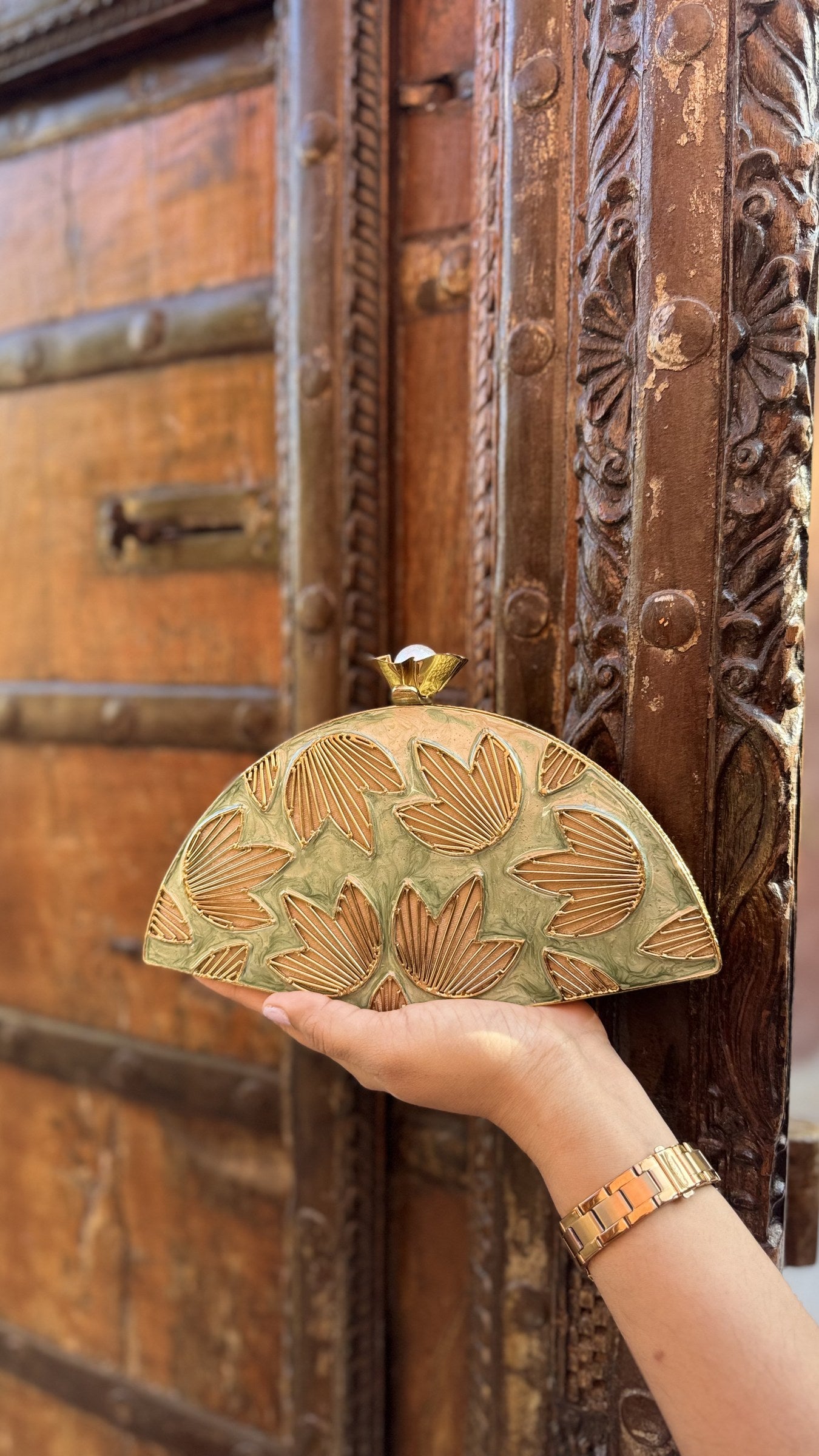 Front view of the Mint Muse clutch, highlighting its elongated rectangular frame and gold borders.