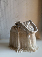 Close-up of the delicate beads and metallic threads on the embroidered panel of the Mira Potli.