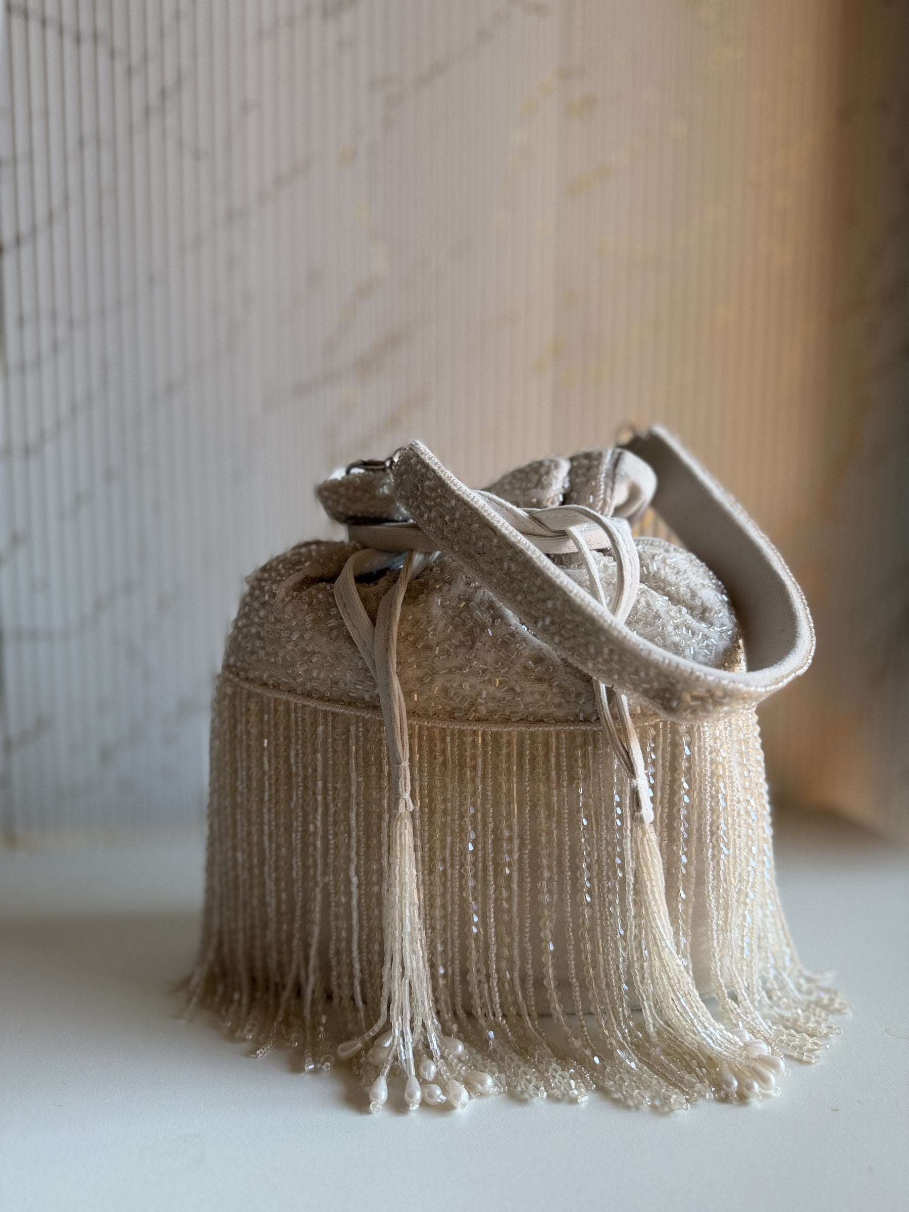 Close-up of the delicate beads and metallic threads on the embroidered panel of the Mira Potli.
