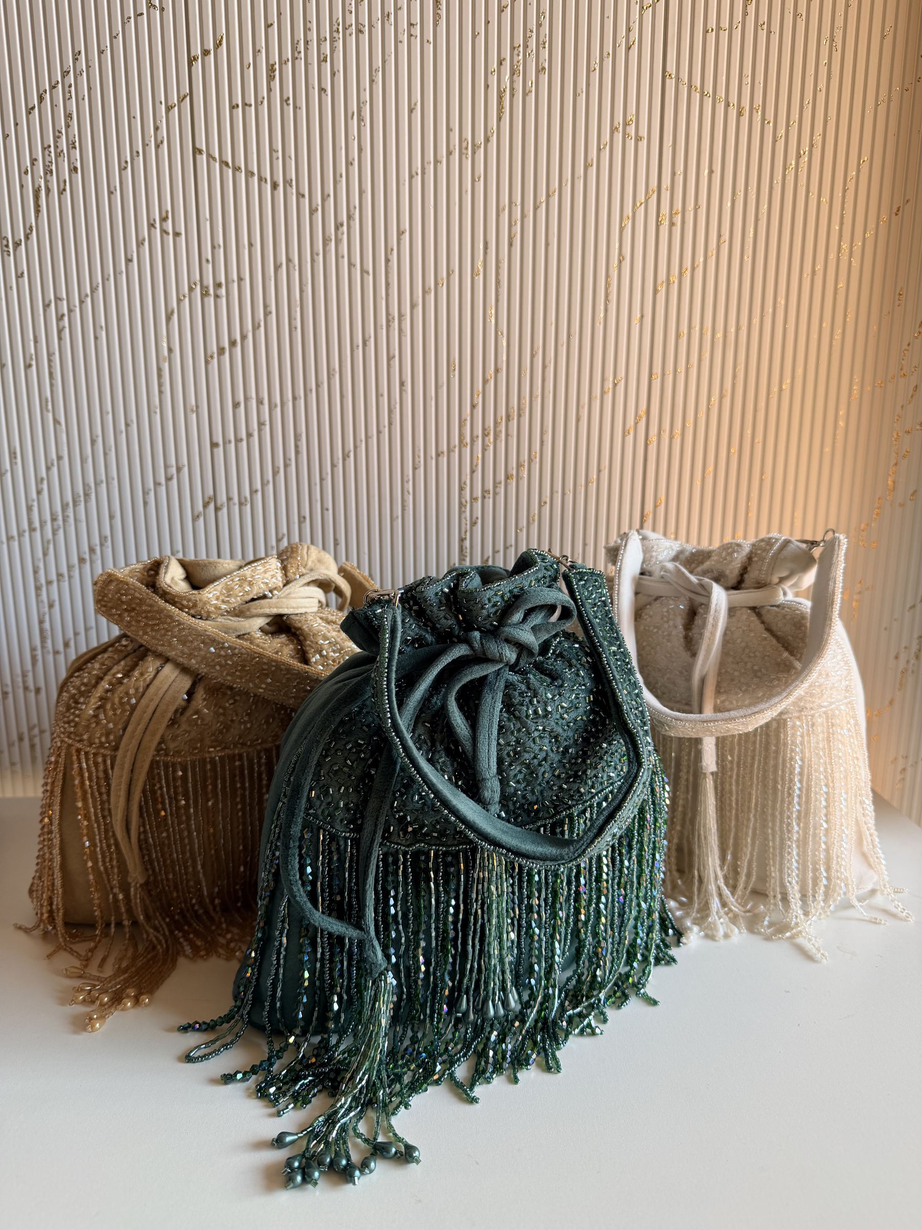 The Mira Suede Potli closed with its drawstring ties, showing the rich, soft folds of the fabric.