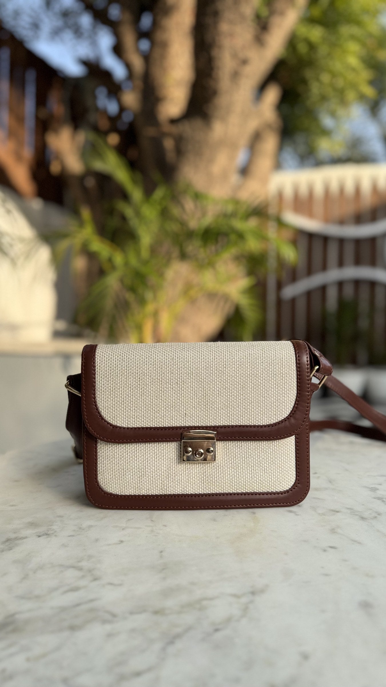 Rear angle of the Mocha Jute sling showing the clean leather back panel and buckle attachments.