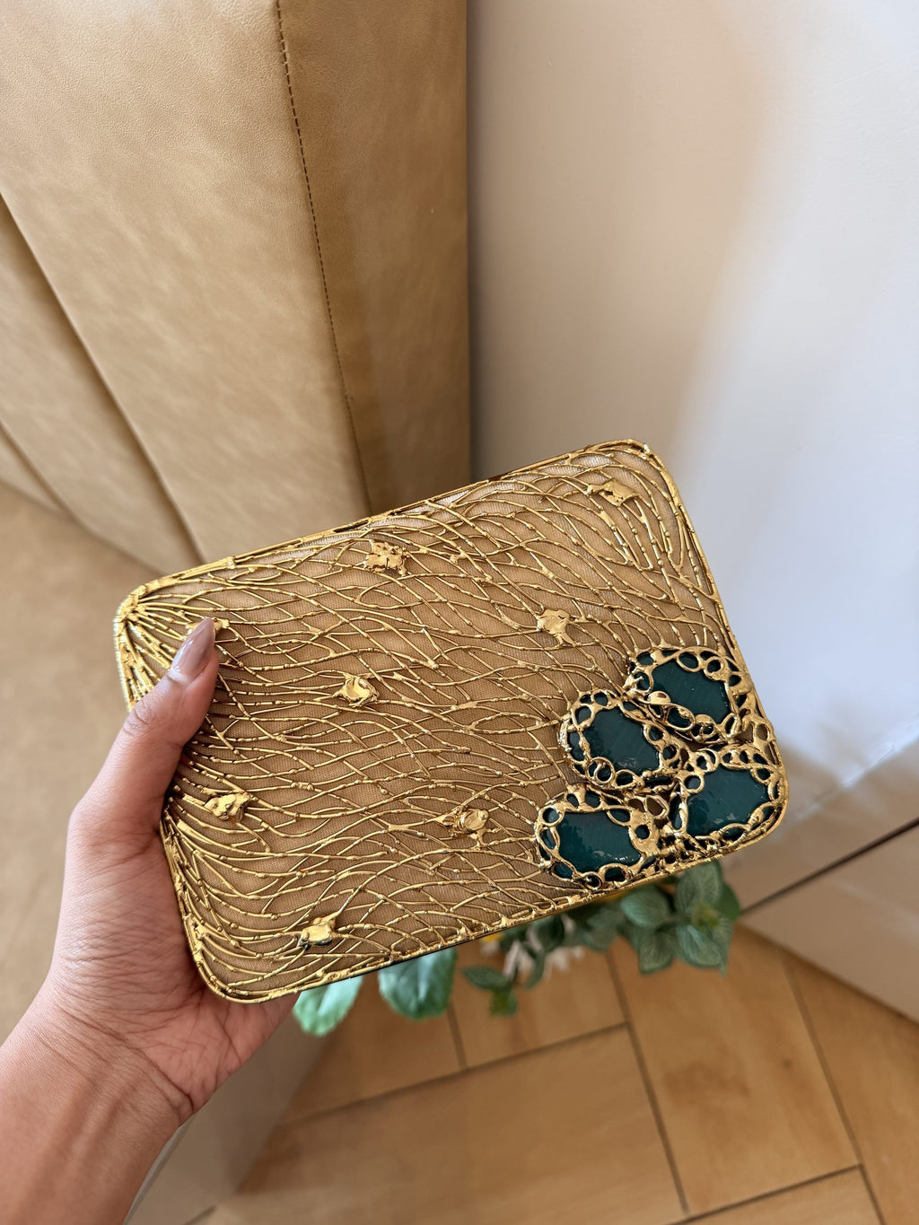 Front view of the Molten Luxe clutch, highlighting the layout of the gemstone rows.