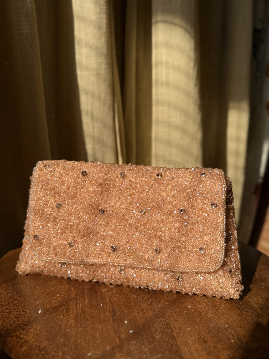 Moonbeam Crystal flap bag displaying its silver-tone crystal embellishments and short beaded handle.