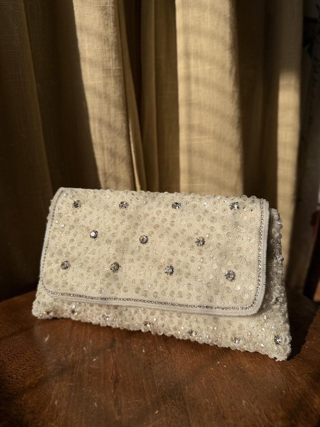 Side angle of the Moonbeam Crystal clutch, illustrating its structured rectangular depth.