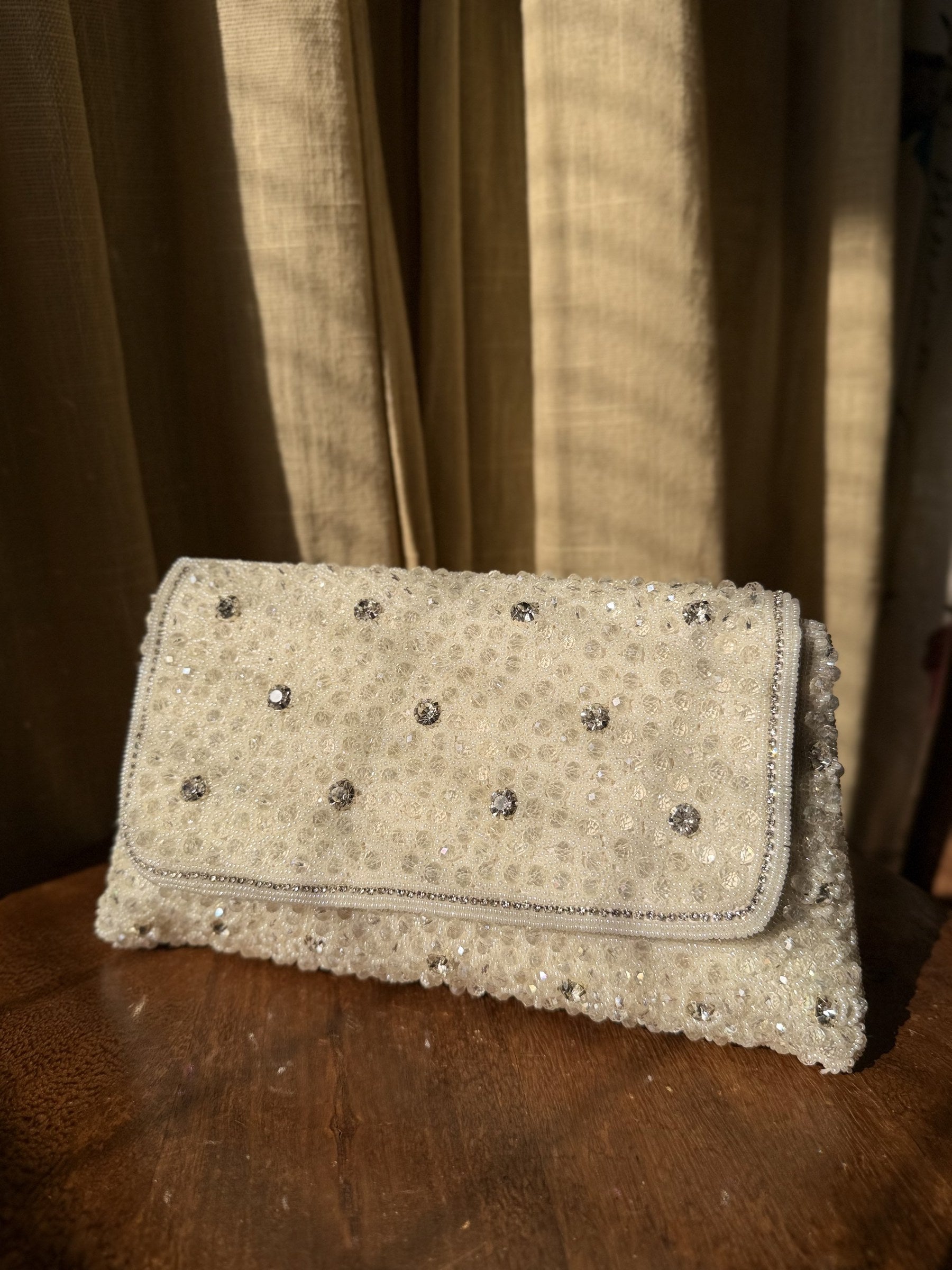 Side angle of the Moonbeam Crystal clutch, illustrating its structured rectangular depth.