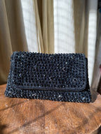 Open view of the Moonbeam Crystal handbag showing the secure magnetic snap and fabric-lined interior.