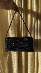 Flat lay of the Moonbeam Crystal clutch next to matching evening accessories and footwear.