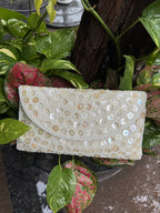 Angled view of the Ocean's Grace bag with its silver-tone metal sling chain attached.