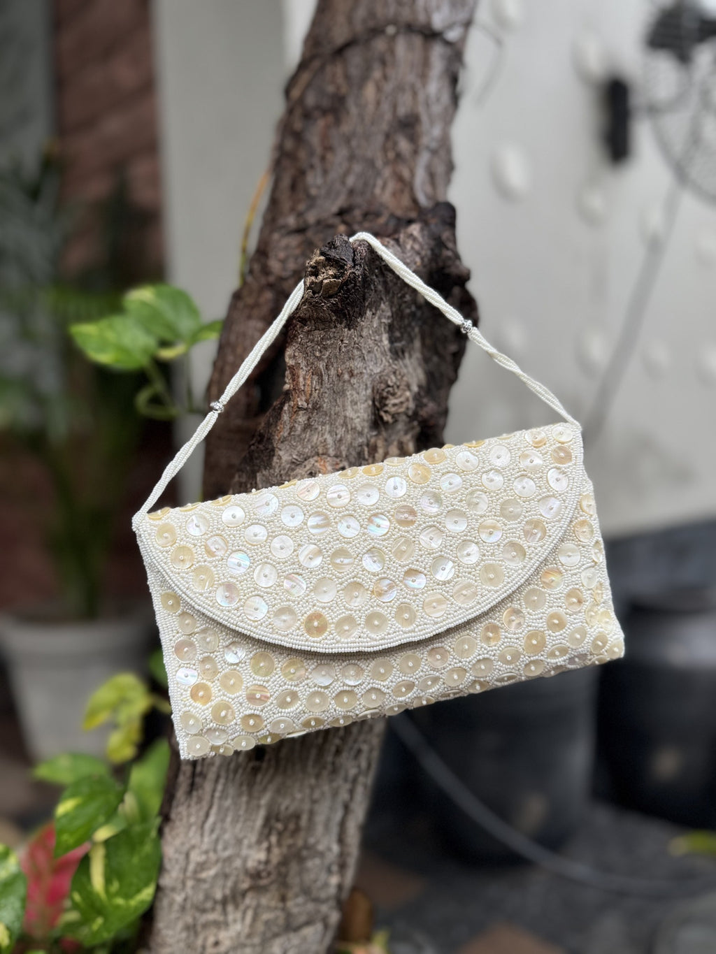 Open view of the Ocean's Grace handbag displaying its internal fabric lining and secure magnetic snap.