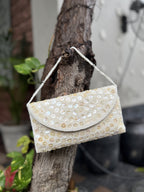 Open view of the Ocean's Grace handbag displaying its internal fabric lining and secure magnetic snap.