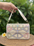 Front view of the Pastella Clutch, showing its soft pastel shimmer fabric and gold frame clasp.