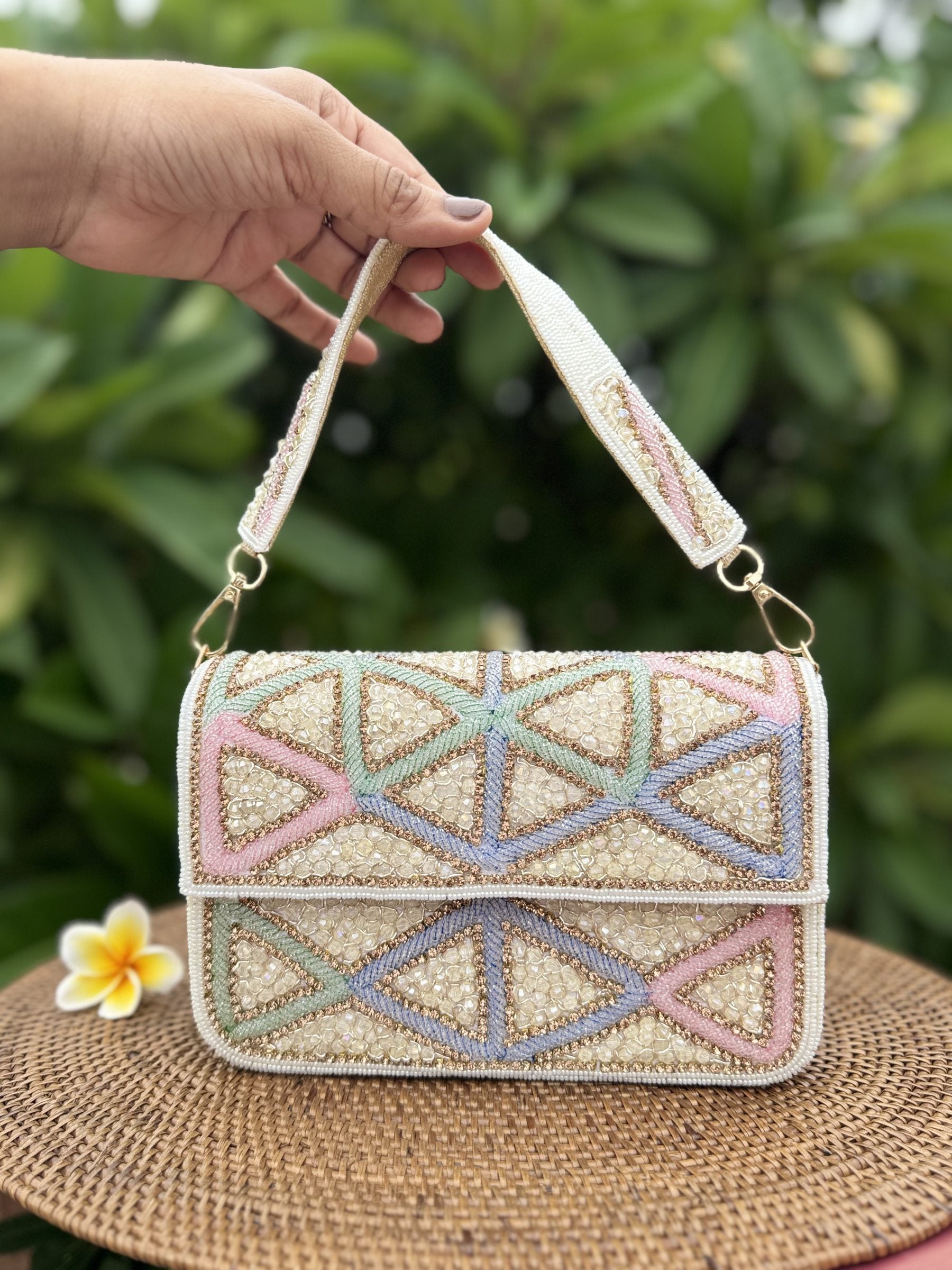 Front view of the Pastella Clutch, showing its soft pastel shimmer fabric and gold frame clasp.