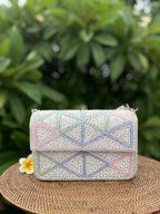 Top view of the Pastella clutch showing the clasp opening and gold hinge.