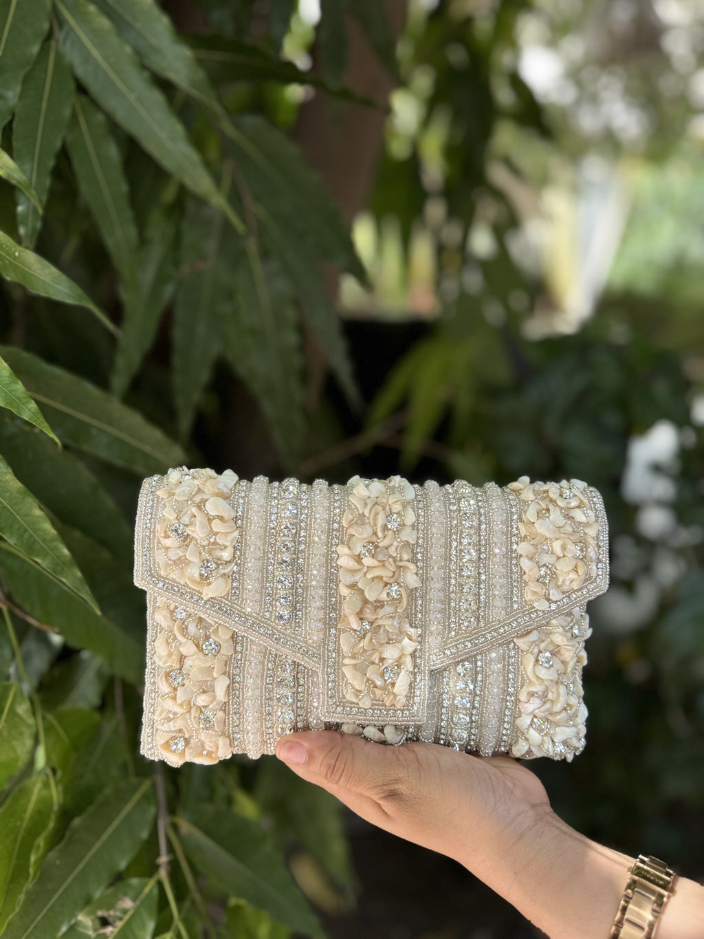 Riwayat Fold heritage bag displaying its traditional multicolored beadwork and gold-tone sling chain.