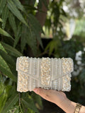 Riwayat Fold heritage bag displaying its traditional multicolored beadwork and gold-tone sling chain.