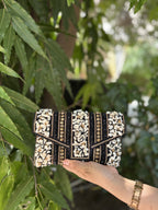Detailed view of the handcrafted envelope fold and traditional bead patterns on the Riwayat bag.