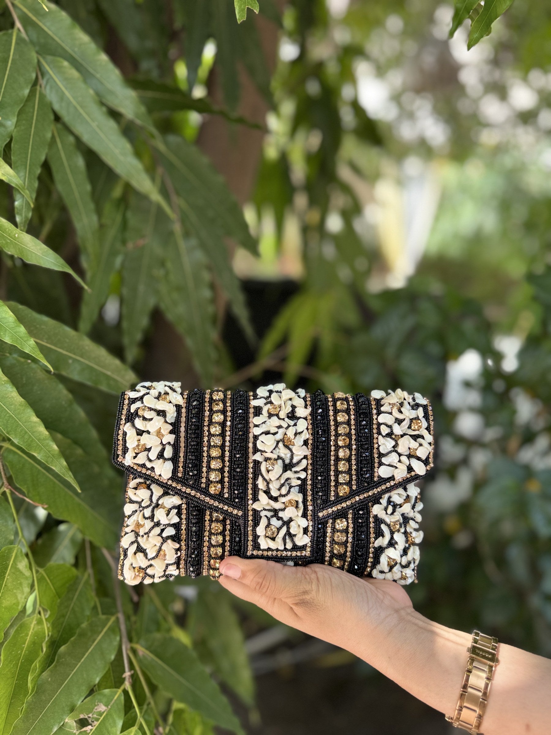 Detailed view of the handcrafted envelope fold and traditional bead patterns on the Riwayat bag.