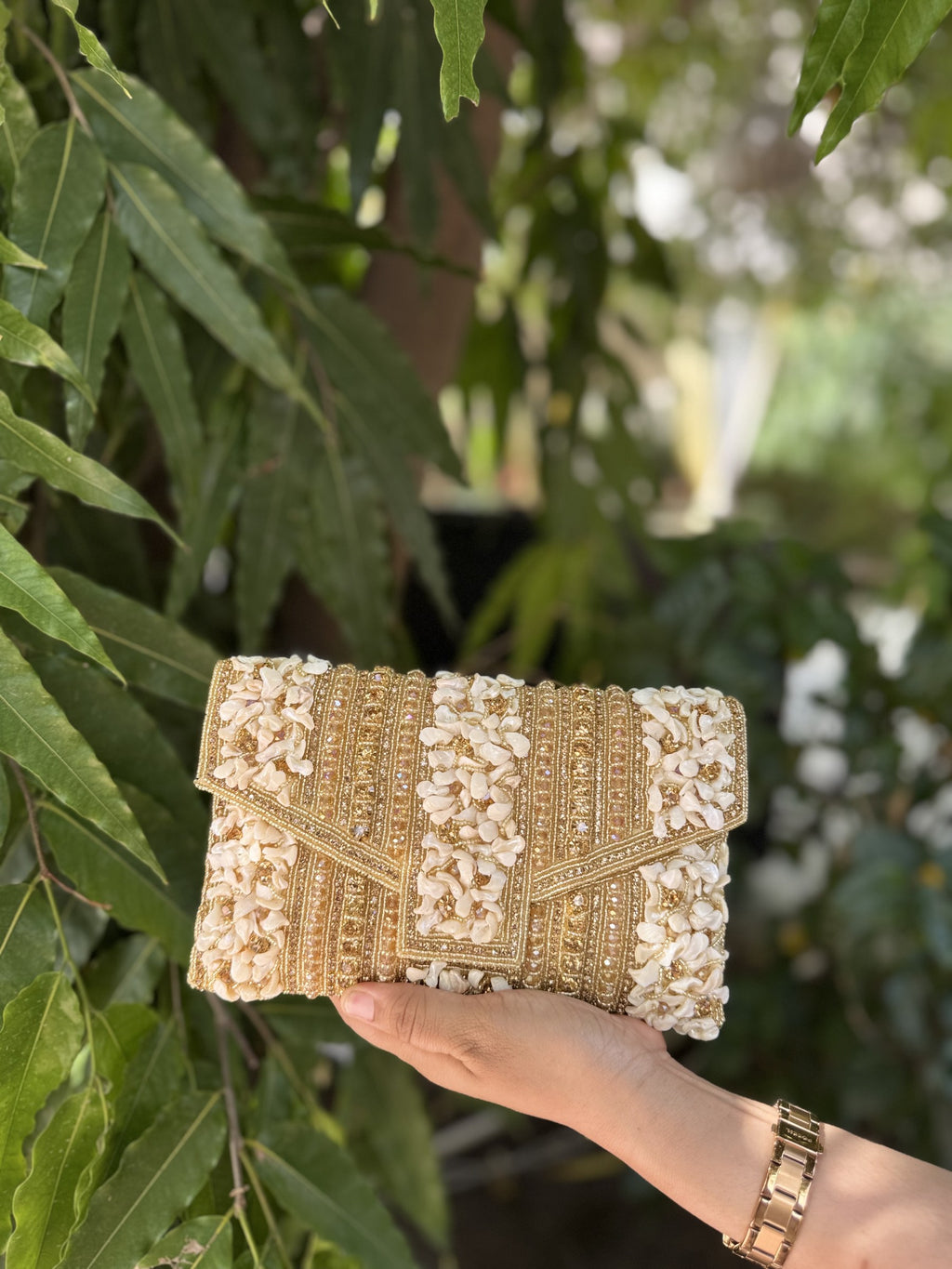 Side profile of the Riwayat Fold clutch, illustrating its envelope-fold design and depth.