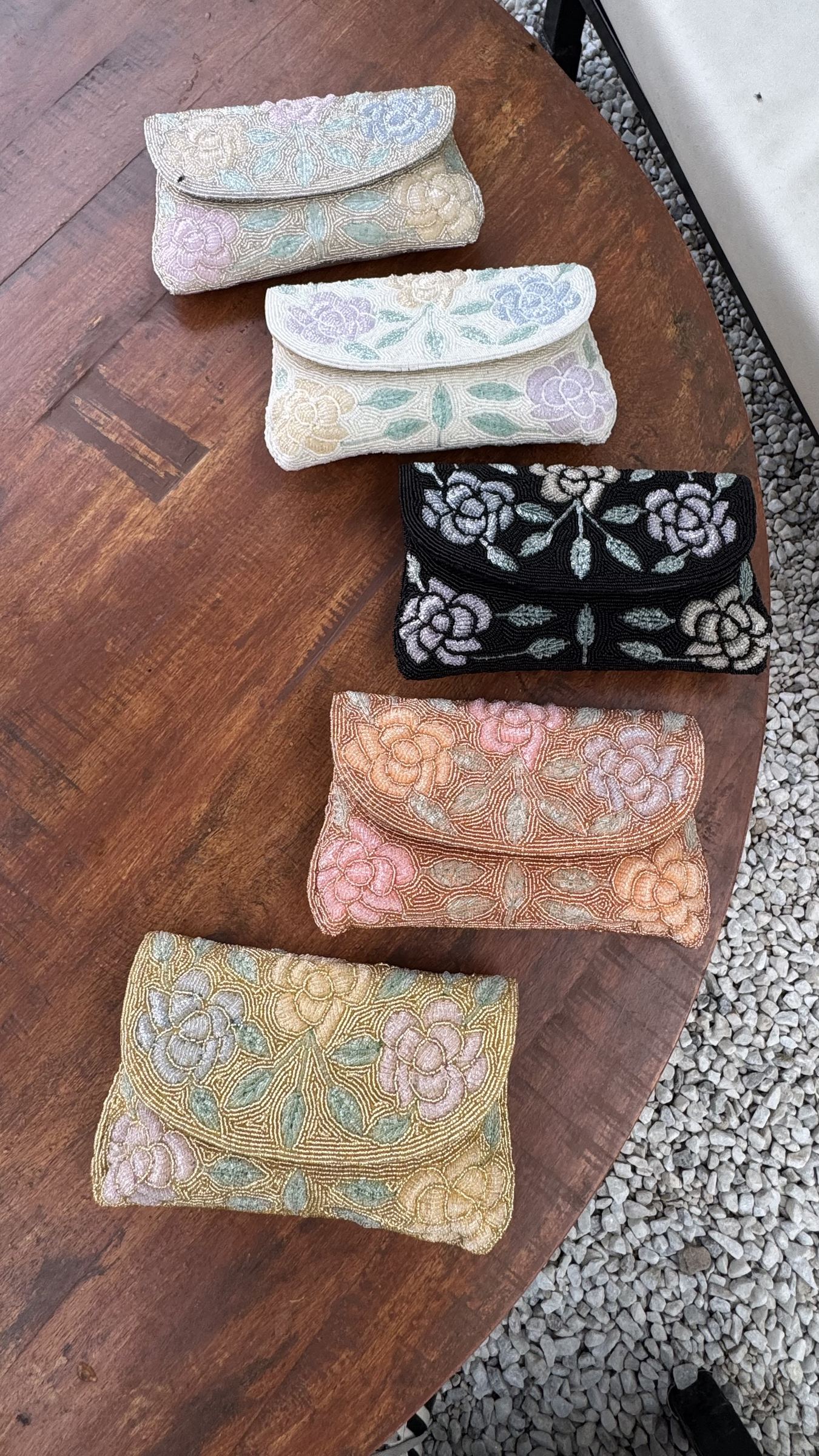 Front view of the Rosette Flap bag, showing the details of the embroidered rose blossoms.