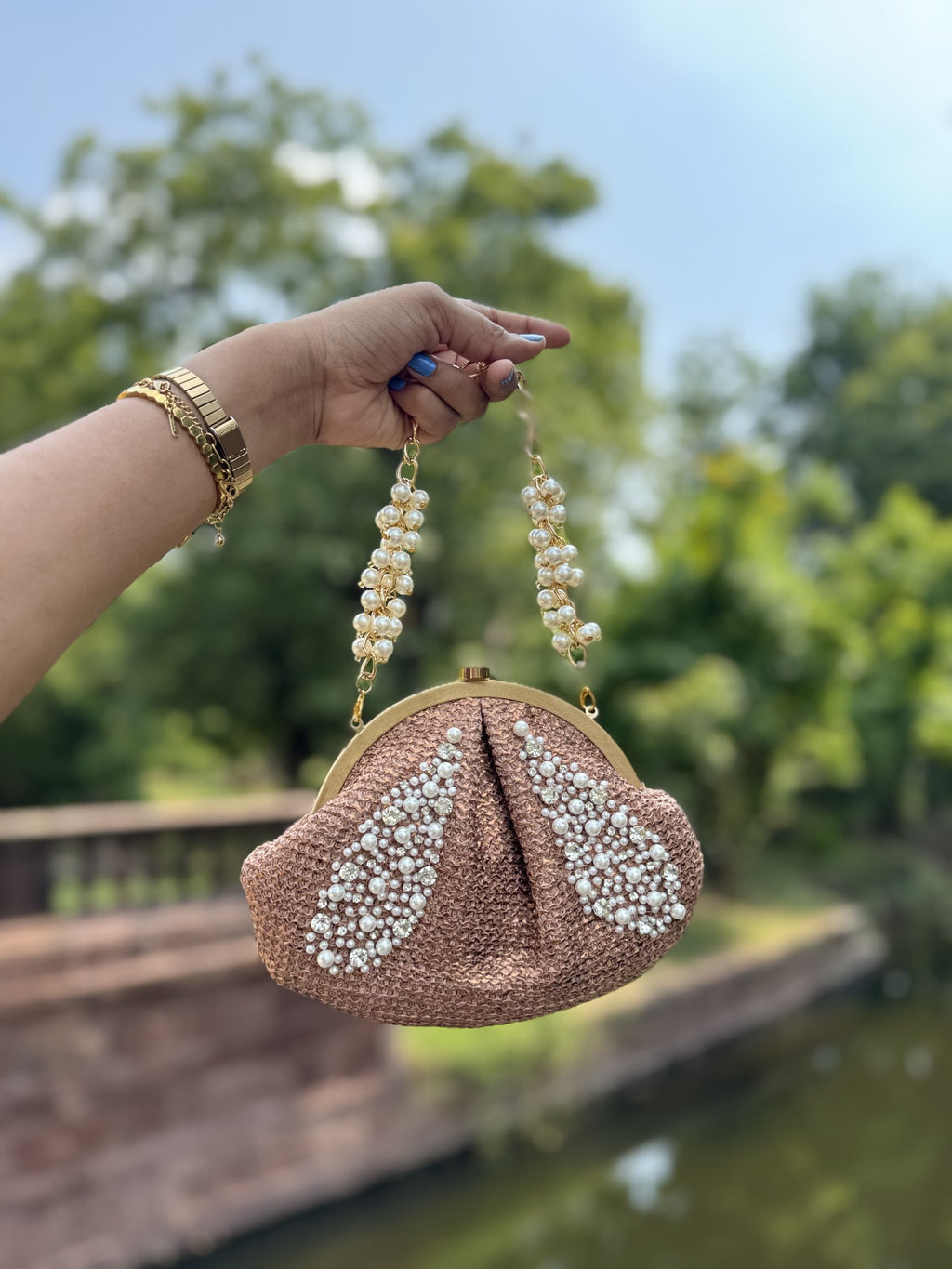Flat lay of the Sands & Pearls bag with beach accessories and sunglasses.