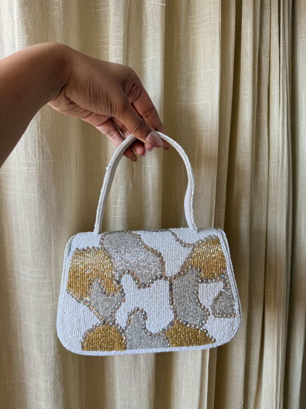 Side panel view of the Sera bag showcasing its structured rectangular frame.