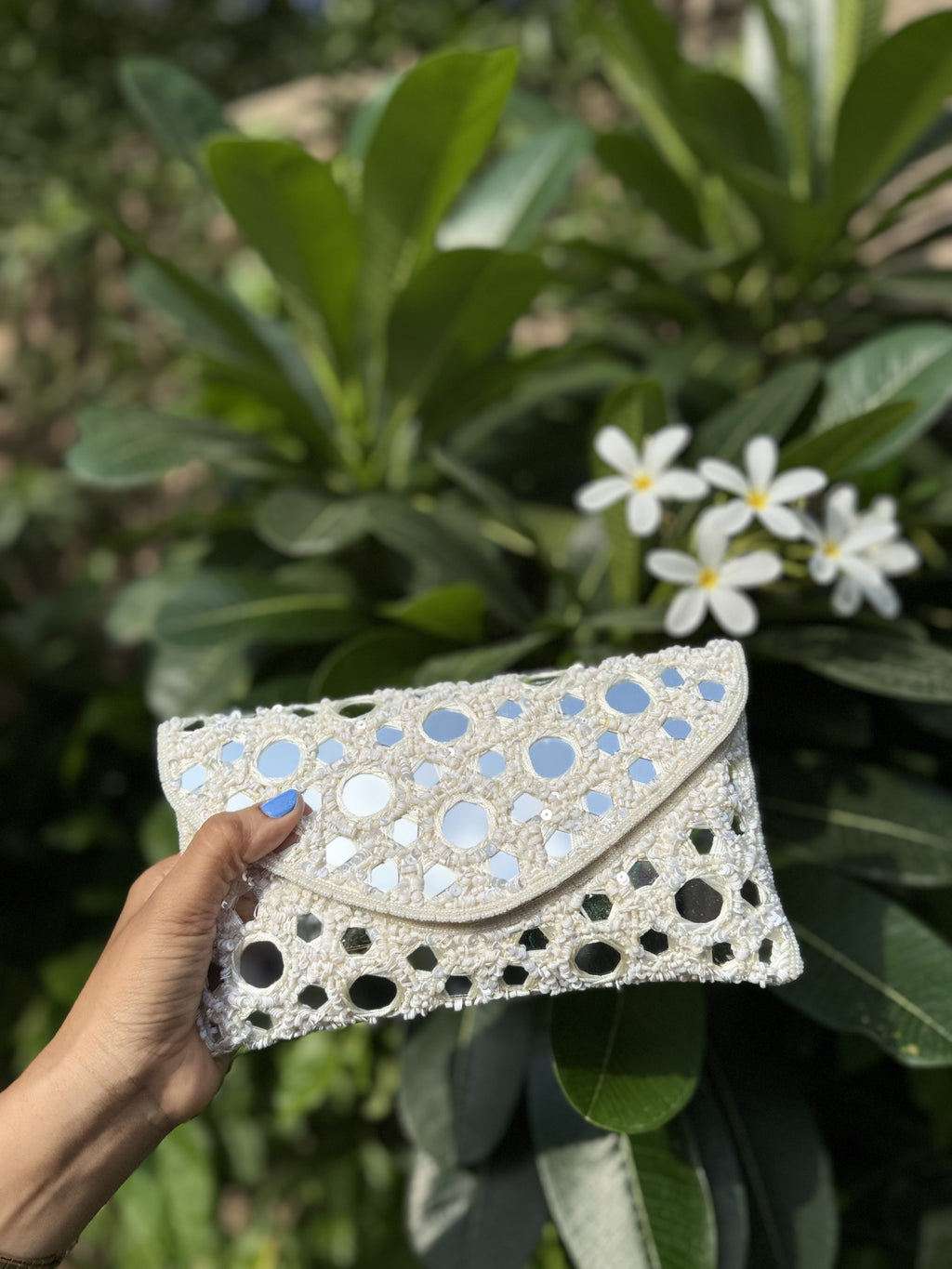 Sheesha Flap bag displaying its handcrafted mirror work and silver-tone sling chain.